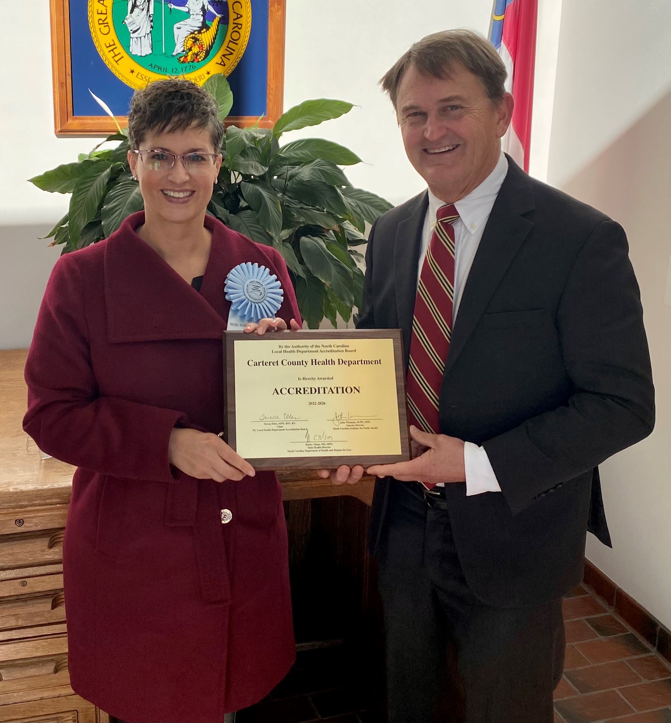 Nina Oliver and Dr. Williams hold accreditation plaque